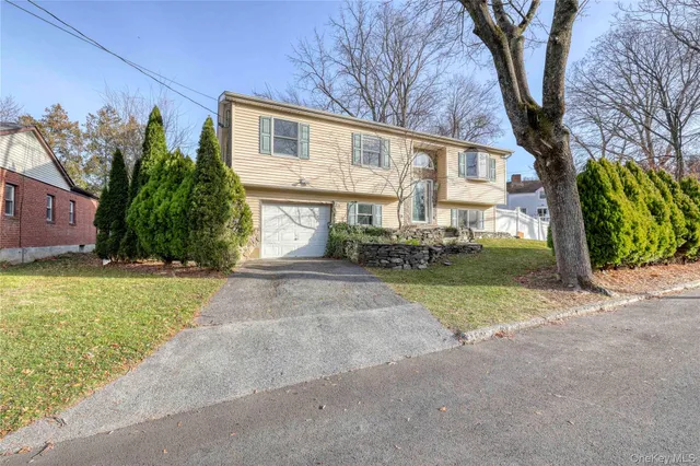 a view of a house with a yard and pathway