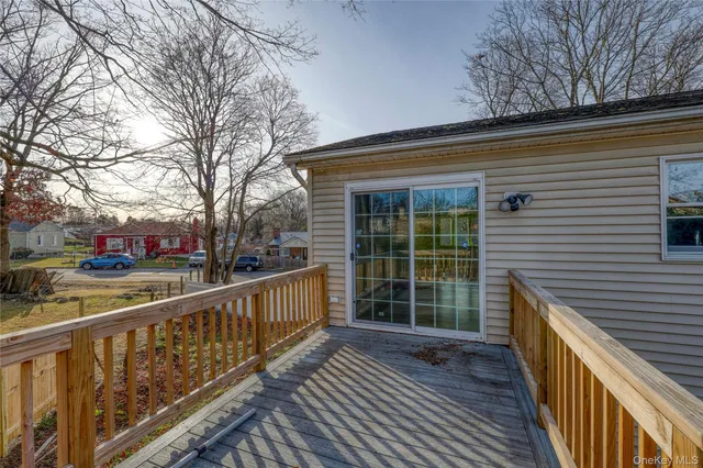 a view of a street with wooden stairs and a large tree