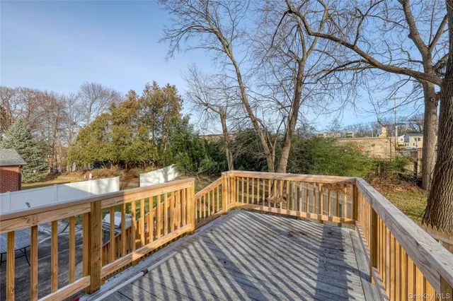 a view of balcony with wooden fence and trees