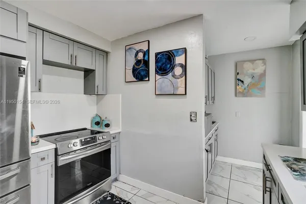 a kitchen with a stove and a refrigerator