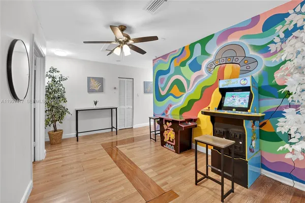 a living room filled with furniture and paintings on the wall
