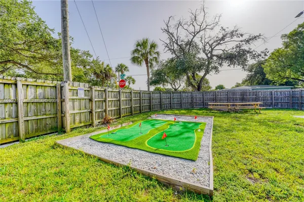 a view of backyard with swimming pool and seating
