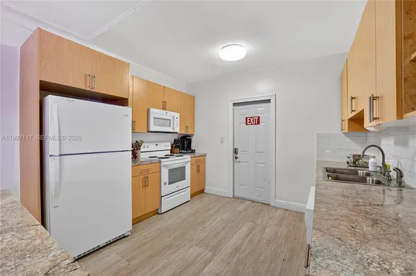 a kitchen with a refrigerator sink and stove
