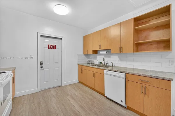 a kitchen with sink cabinets and window