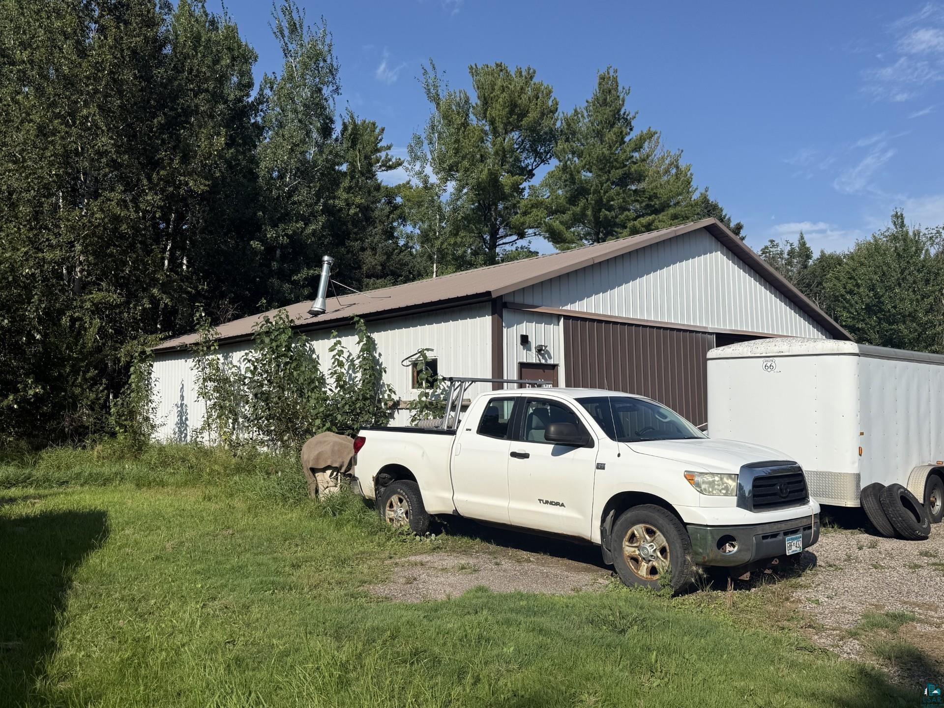 124 Nynas Road Esko, MN 55733 - Photo 14 of 14 Metal-sided structure featuring a gable roof and mature tree surroundings