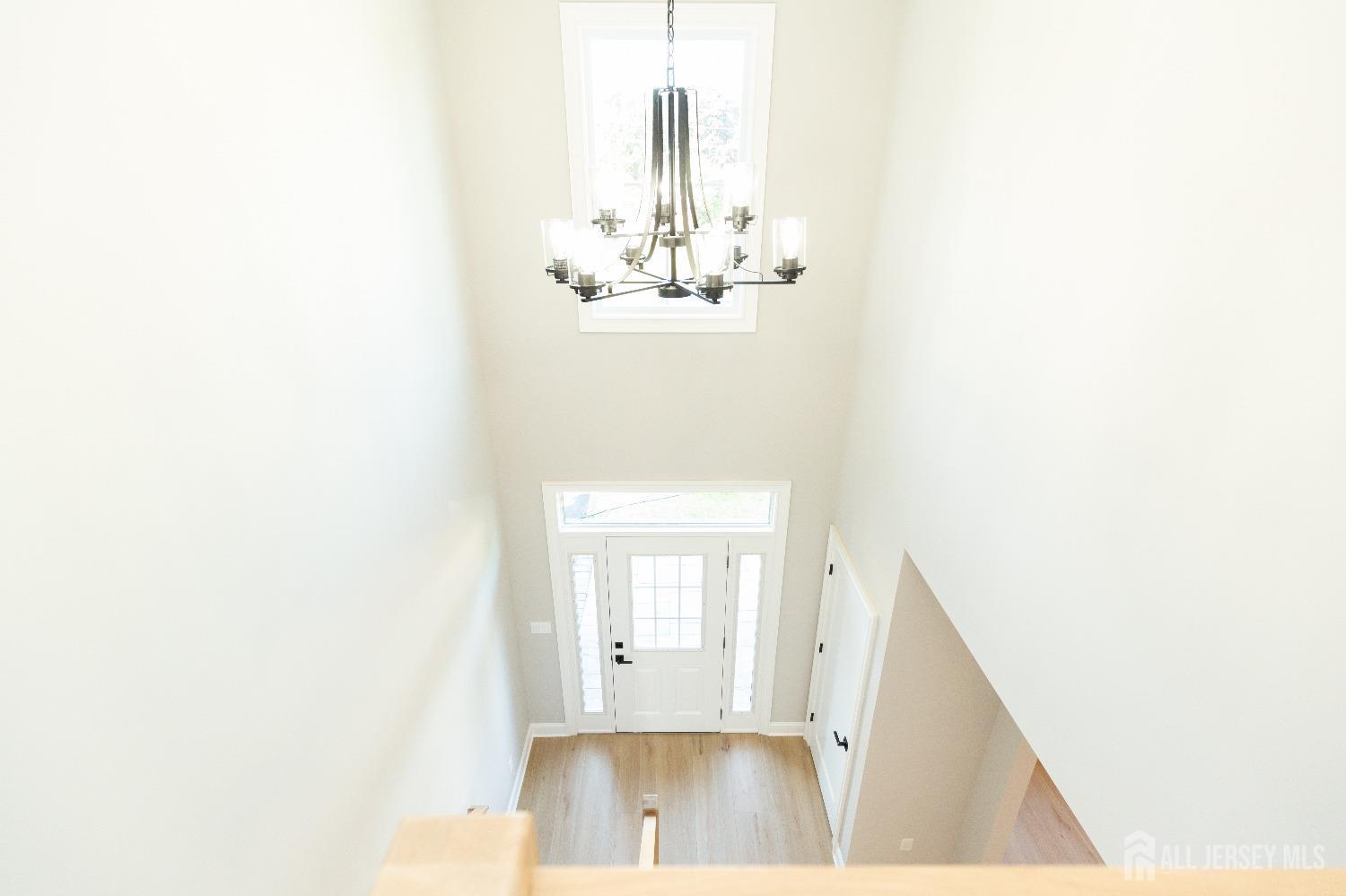 32 Weldon Road Edison, NJ 08817 - Photo 28 of 59 a view of a hallway with wooden floor and a large mirror