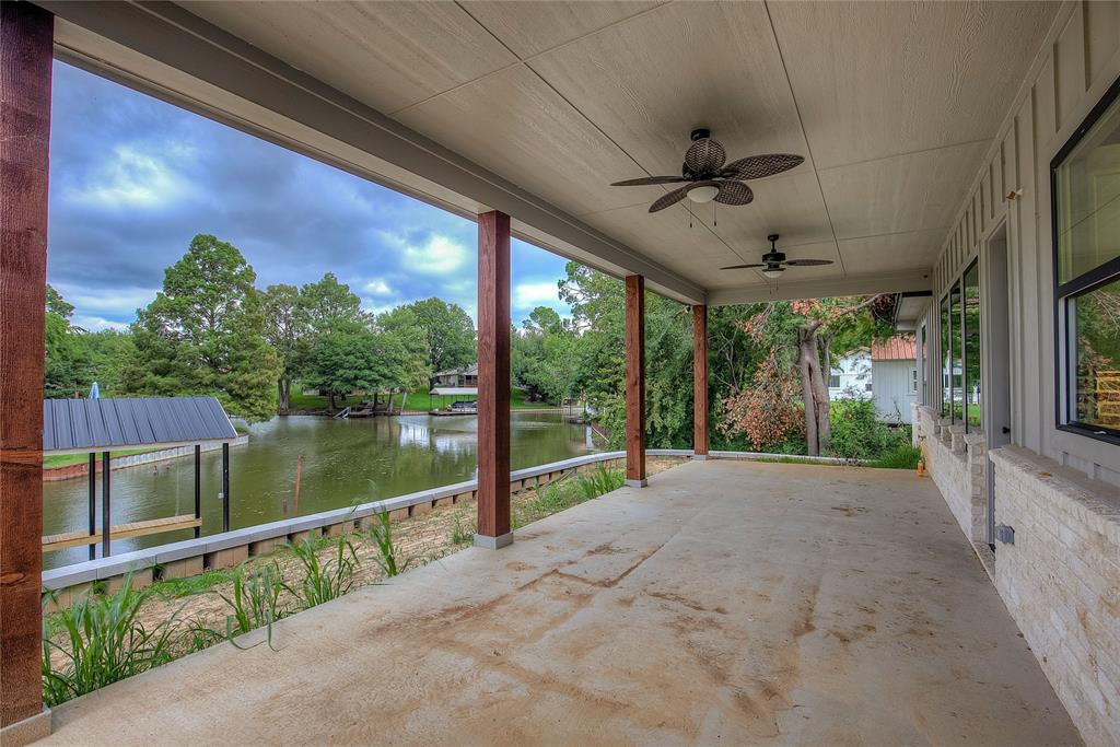 405 Door Key Ranch Road Trinidad, TX 75163 - Photo 24 of 28 View of patio with a water view, ceiling fan, and a dock