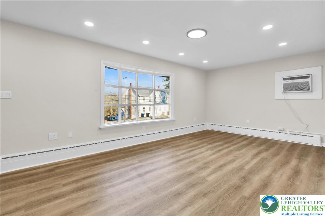 416 Main Street Stockertown, PA 18083 - Photo 11 of 29 an empty room with wooden floor and windows