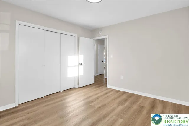 a view of a room with wooden floors and windows