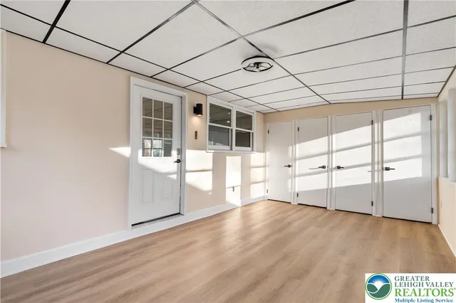 a view of a hallway with wooden floor and closet