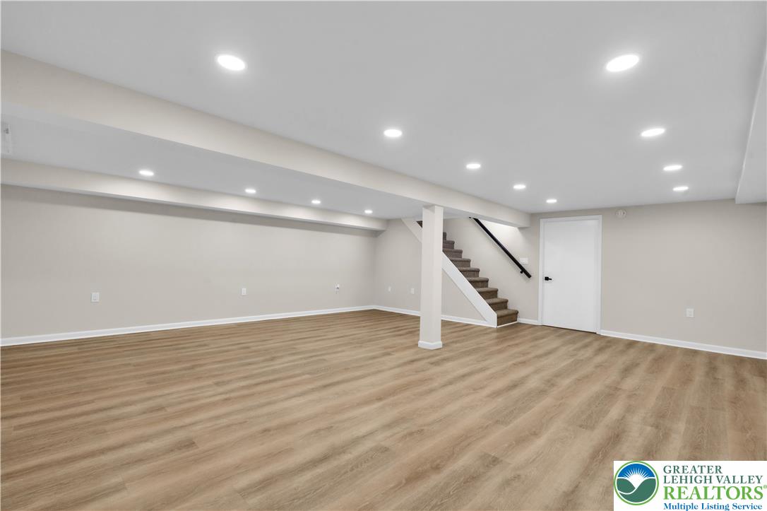 416 Main Street Stockertown, PA 18083 - Photo 21 of 29 an empty room with wooden floor and staircase