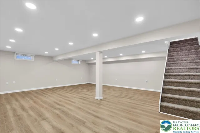 a view of a house with a small yard and a garage