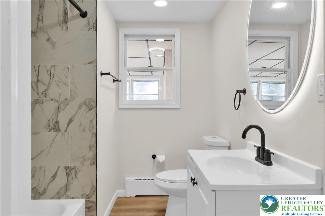 416 Main Street Stockertown, PA 18083 - Photo 6 of 29 a close view of a sink a mirror and a shower in a bathroom