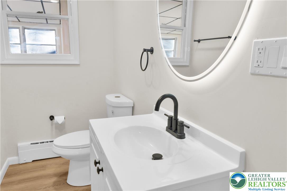 416 Main Street Stockertown, PA 18083 - Photo 7 of 29 a bathroom with a sink a toilet and a mirror