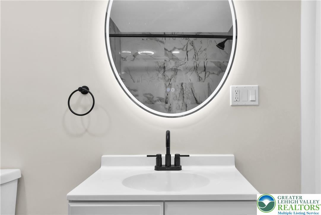 416 Main Street Stockertown, PA 18083 - Photo 8 of 29 a bathroom with a mirror and a sink