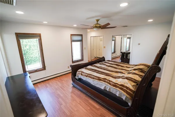 a bedroom with a bed and a ceiling fan