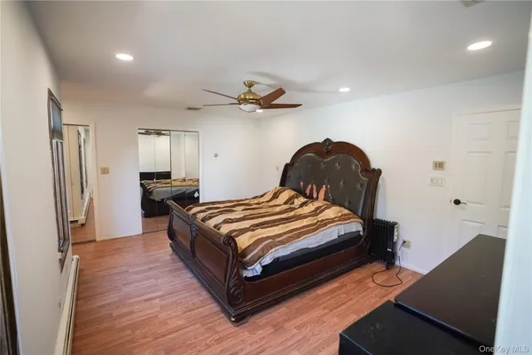 a bedroom with a bed and a chair