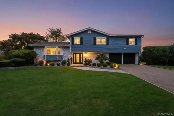 a view of a house with a yard and a garden