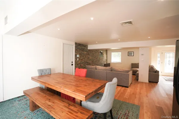 a living room with dining room and wooden floor