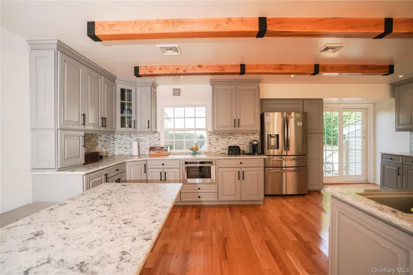 a kitchen with stainless steel appliances kitchen island granite countertop a stove and cabinets