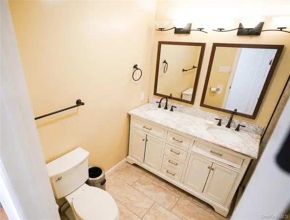 a open kitchen with granite countertop a stove top oven a sink dishwasher and white cabinets with wooden floor