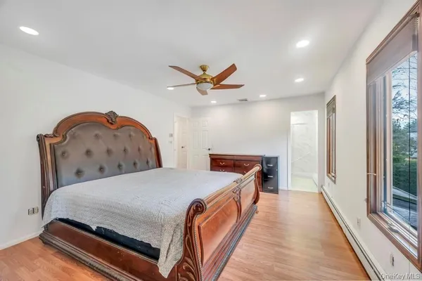 a bathroom with a granite countertop sink toilet and mirror