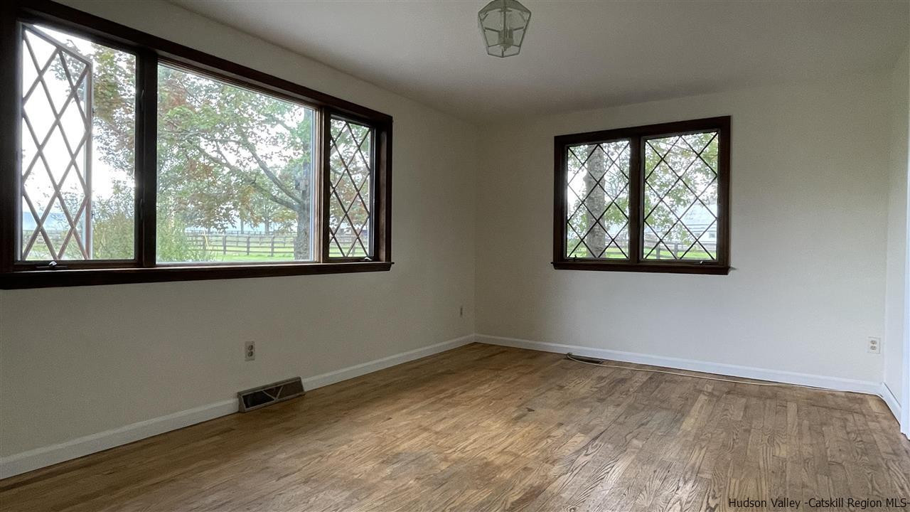 791 Hoagerburgh Road Wallkill, NY 12589 - Photo 12 of 24 a view of an empty room with wooden floor and a window