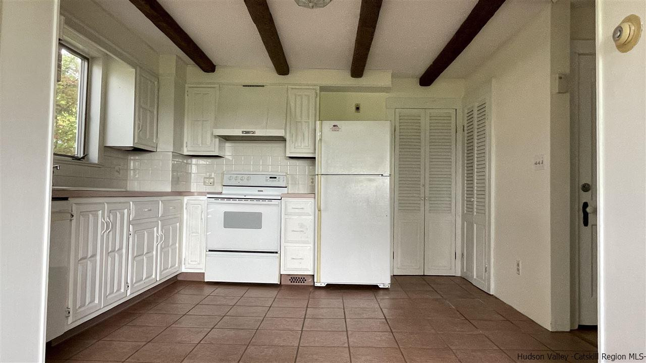 791 Hoagerburgh Road Wallkill, NY 12589 - Photo 4 of 24 a kitchen with white cabinets and white appliances