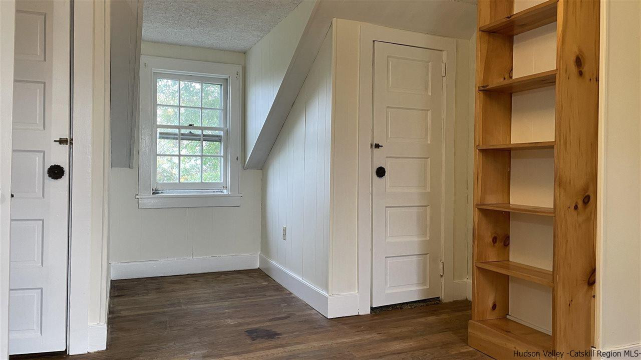 791 Hoagerburgh Road Wallkill, NY 12589 - Photo 10 of 24 a view of an empty room with wooden floor and a window