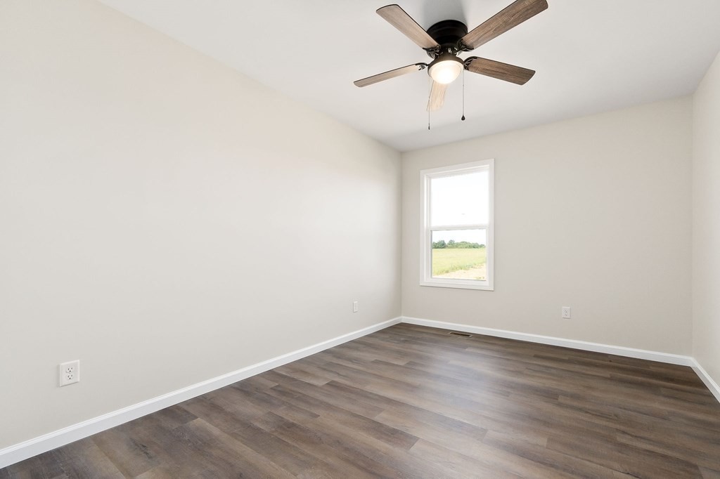 14305 Old Kentucky Road Walling, TN 38587 - Photo 15 of 31 wooden floor in an empty room with a window