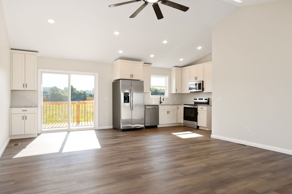 14305 Old Kentucky Road Walling, TN 38587 - Photo 6 of 31 a view of kitchen with refrigerator microwave and wooden floor