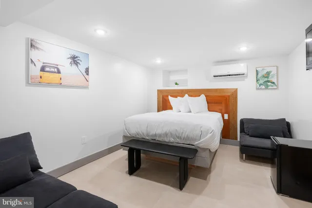 a bedroom with a bed and couch