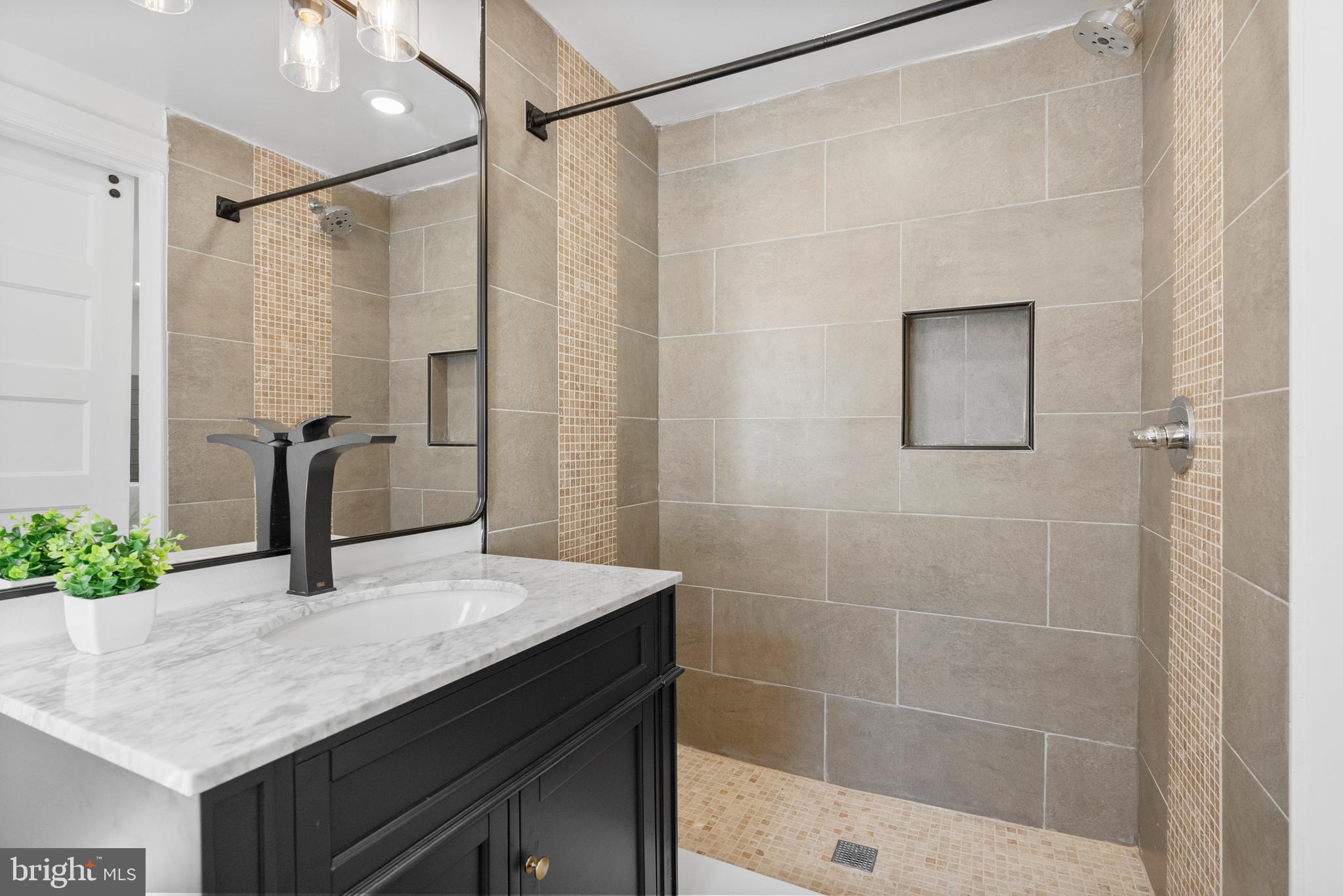 2305 North 50th Street Philadelphia, PA 19131 - Photo 29 of 33 a bathroom with a sink vanity granite and shower