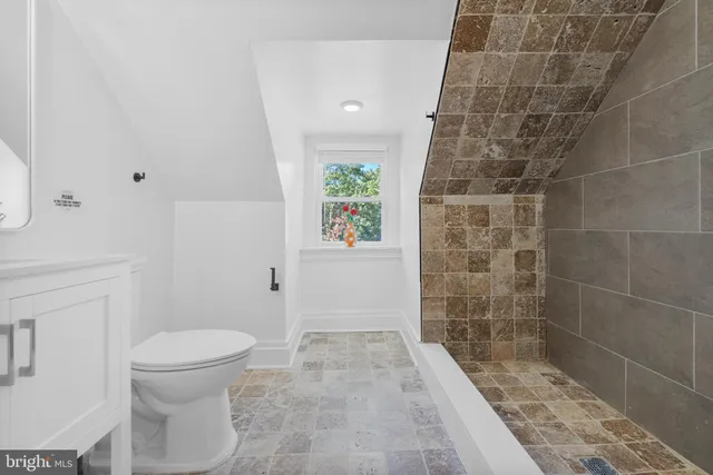 a bedroom with a bed and a mirror