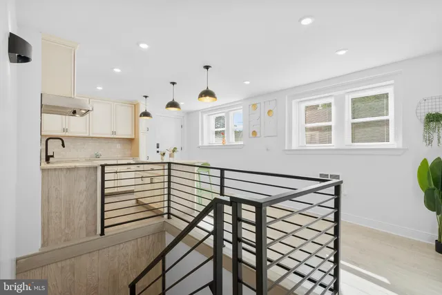 a view of kitchen with stainless steel appliances cabinets and wooden floor