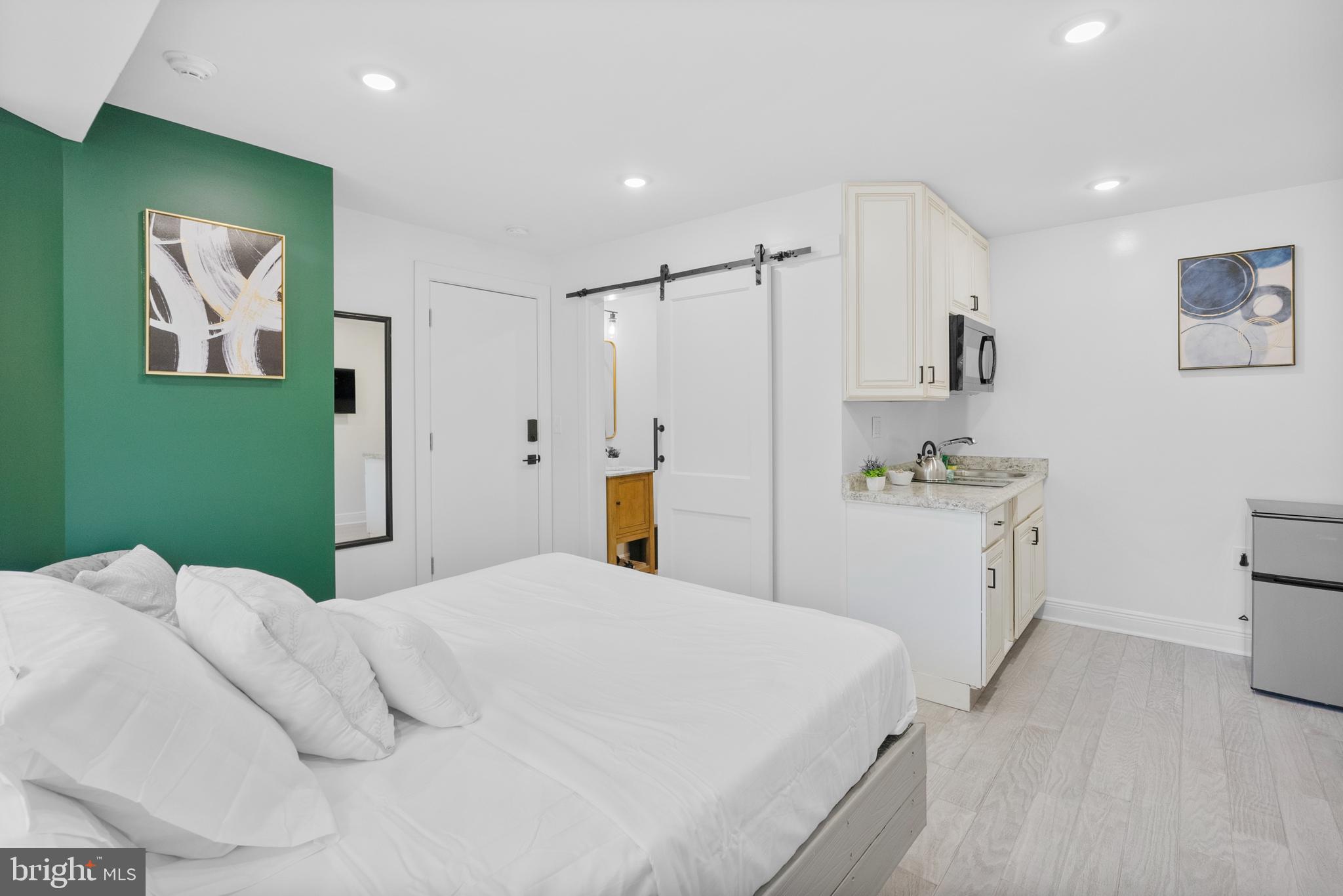 2305 North 50th Street Philadelphia, PA 19131 - Photo 9 of 33 a bedroom with a bed and a refrigerator