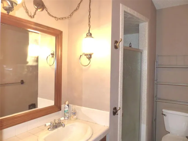 a bathroom with a sink and shower