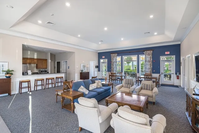 a view of a patio with couches table and chairs with plants and trees