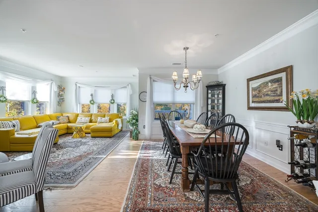 a view of a dining room with furniture and chandelier