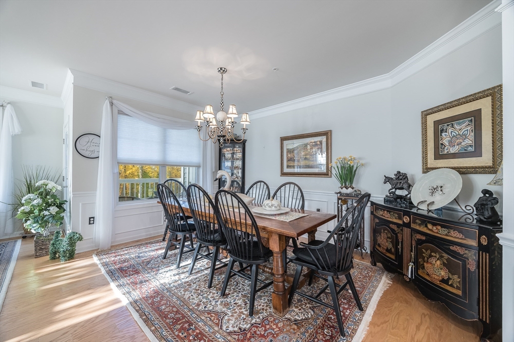 4 Francis Drive, Unit 207 Andover, MA 01810 - Photo 7 of 21 a view of a dining room with furniture and chandelier