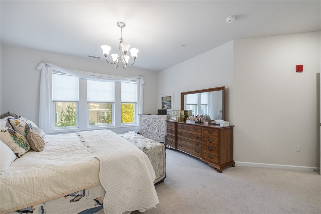 4 Francis Drive, Unit 207 Andover, MA 01810 - Photo 10 of 21 a bed room with a bed and a chandelier