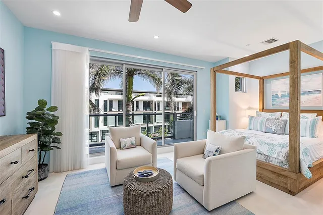 a living room with stainless steel appliances kitchen island granite countertop a stove and a refrigerator