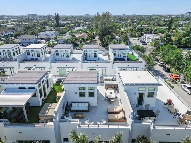 a kitchen with stainless steel appliances kitchen island granite countertop a table and chairs in it