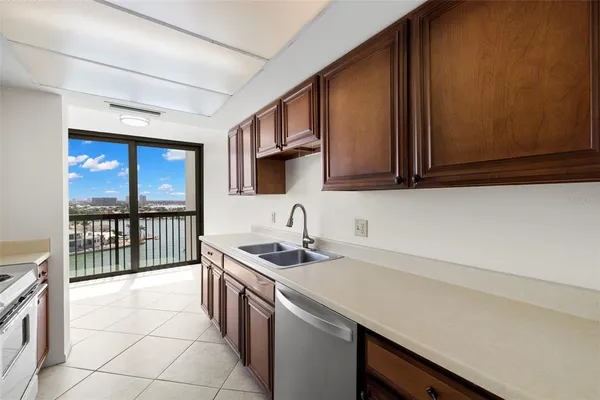a kitchen with stainless steel appliances granite countertop a sink stove and cabinets