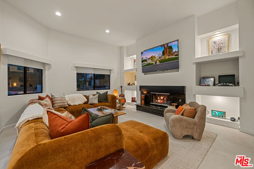 1414 Sagebrush Road Palm Springs, CA 92264 - Photo 18 of 48 a living room with furniture and a fireplace