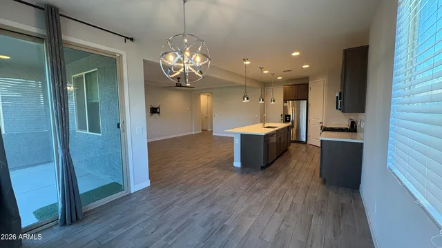 a view of a kitchen with a sink stainless steel appliances and cabinets
