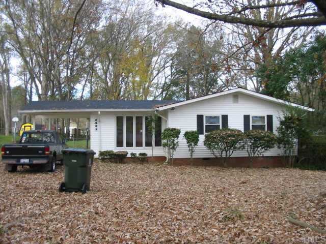 a view of house with outdoor space and garden