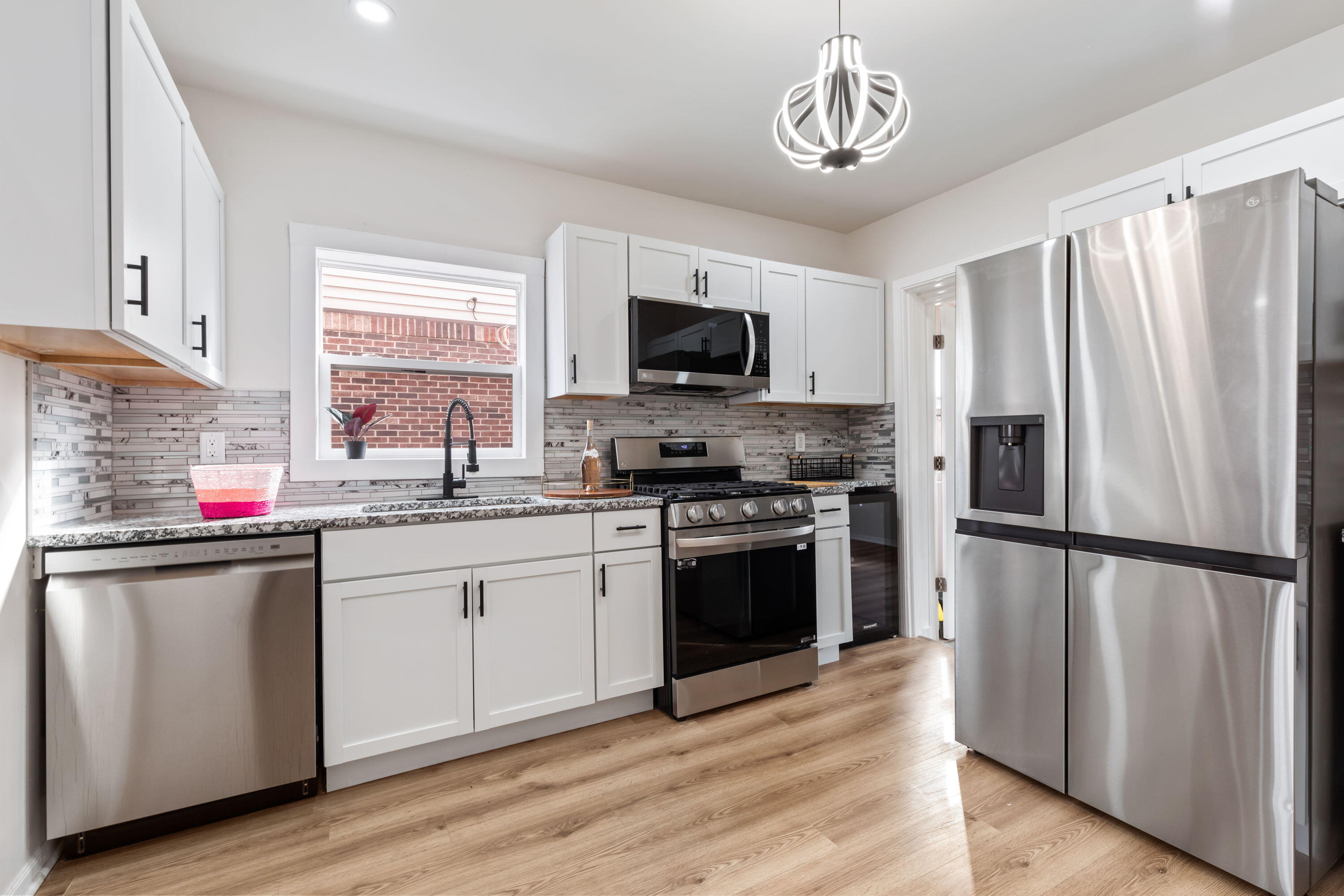 560 Rhode Island Ct. Gary, IN 46402 - Photo 12 of 49 a kitchen with granite countertop a refrigerator stove top oven and sink