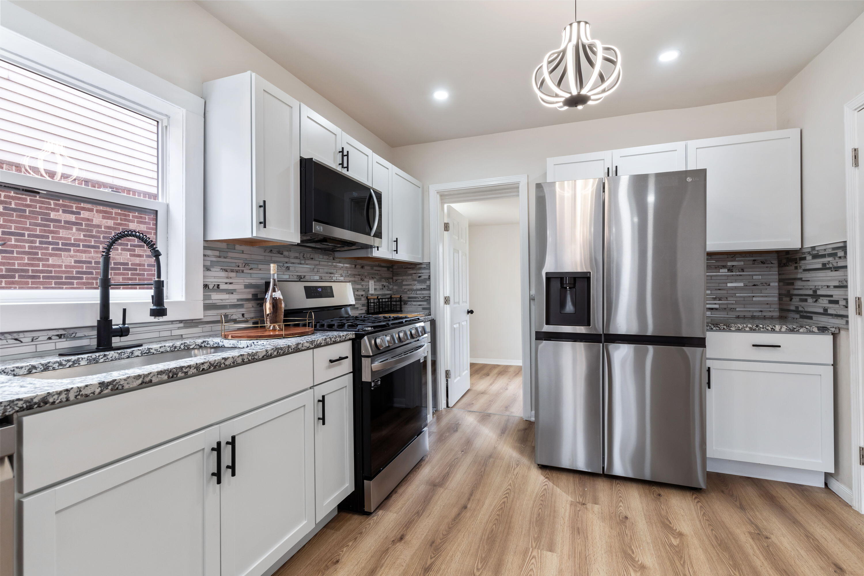 560 Rhode Island Ct. Gary, IN 46402 - Photo 13 of 49 a kitchen with stainless steel appliances a refrigerator sink and microwave