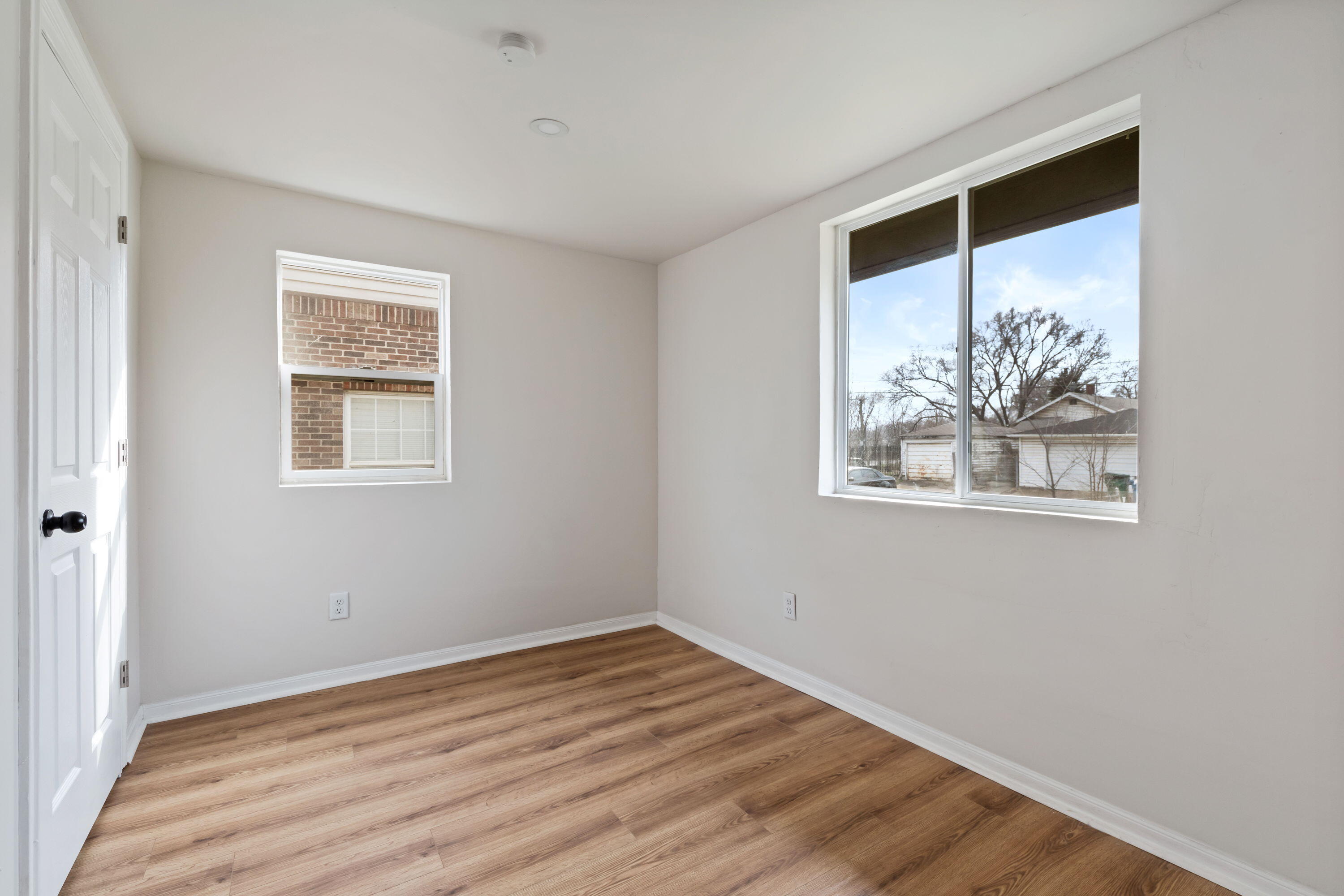 560 Rhode Island Ct. Gary, IN 46402 - Photo 15 of 49 a view of an empty room with wooden floor and a window